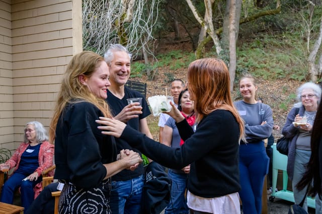 Guests hugging and toasting in the courtyard