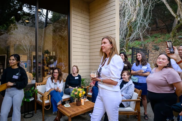 Guests smiling and cheering in the courtyard lounge