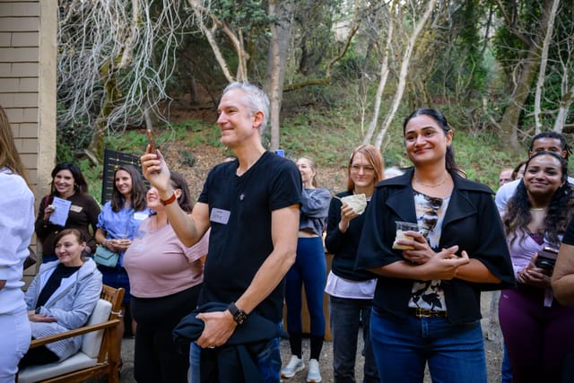 Guests raising their glasses in a toast in the courtyard