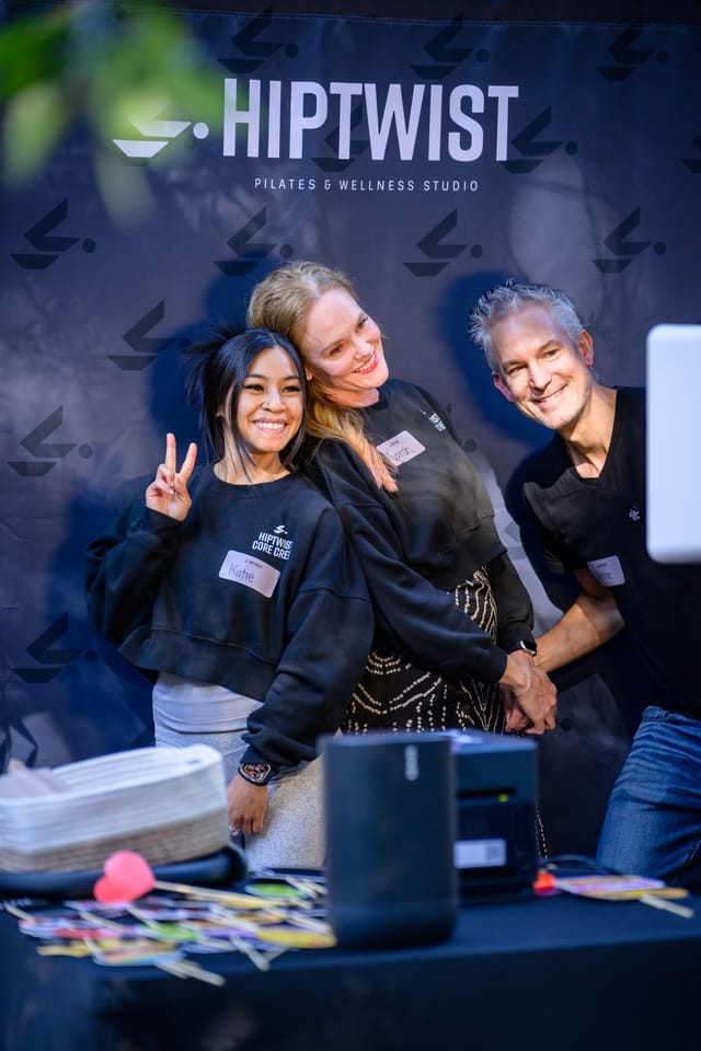 Three guests posing at the photo booth