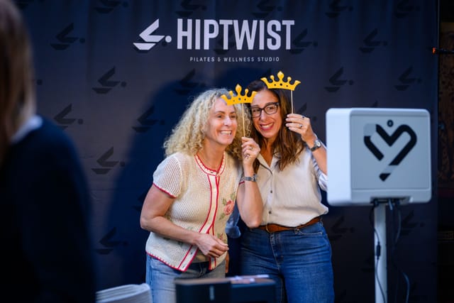 Two guests in crown props at the photo booth