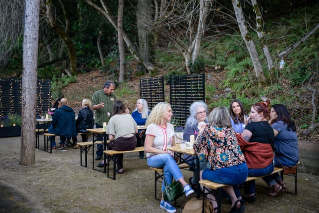 Guests sharing food and conversation at the courtyard tables